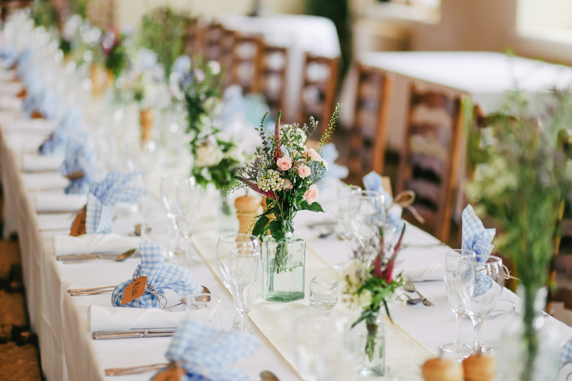 Long candlelit table set for an intimate celebration